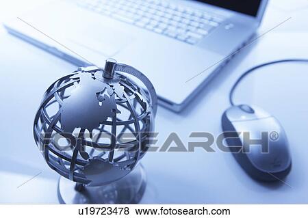 Globe and a laptop View Large Photo Image Stock Photo - Globe and a laptop. Fotosearch