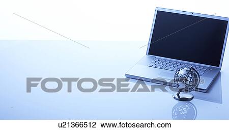 Globe in front of a laptop View Large Photo Image Stock Image - Globe in front of a laptop. Fotosearch