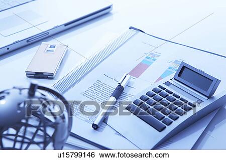 Stock Photograph - Globe on a desk with business accessories. Fotosearch