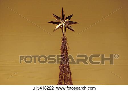 Golden star on Christmas tree View Large Photo Image Stock Image - Golden star on Christmas tree. Fotosearch