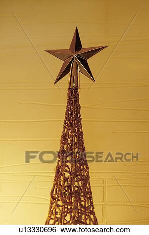 Stock Photograph - Golden star on Christmas tree. Fotosearch