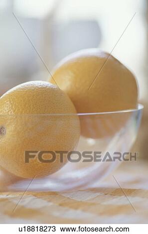 Stock Image - Grapefruits in glass bowl. Fotosearch