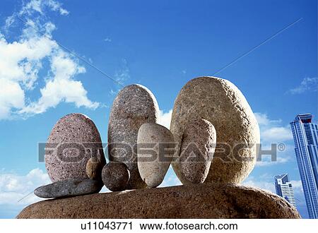 Stock Image - Group of rocks in a city setting. Fotosearch