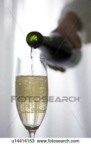Hand pouring champagne into champagne flute View Large Photo Image Stock Image - Hand pouring champagne into champagne flute. Fotosearch