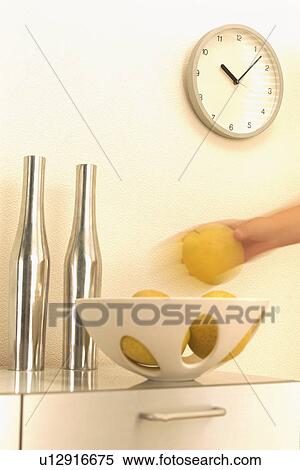 Hand taking grapefruit from bowl View Large Photo Image Stock Photography - Hand taking grapefruit from bowl. Fotosearch