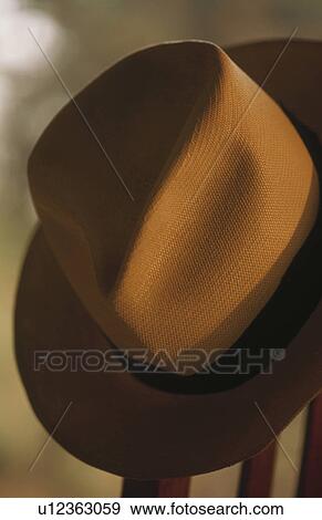 Hat hanging on wooden chair View Large Photo Image Stock Photo - Hat hanging on wooden chair. Fotosearch