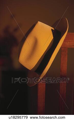 Hat hanging on wooden chair View Large Photo Image Stock Photo - Hat hanging on wooden chair. Fotosearch