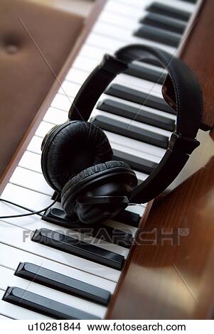 Headphones and a keyboard View Large Photo Image Picture - Headphones and a keyboard. Fotosearch