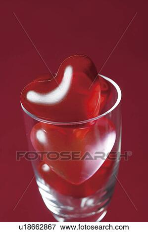 Heart shaped bath beads in a glass View Large Photo Image Stock Photo - Heart shaped bath beads in a glass. Fotosearch