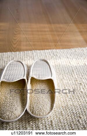 Stock Image - Hemp slippers and rug. Fotosearch