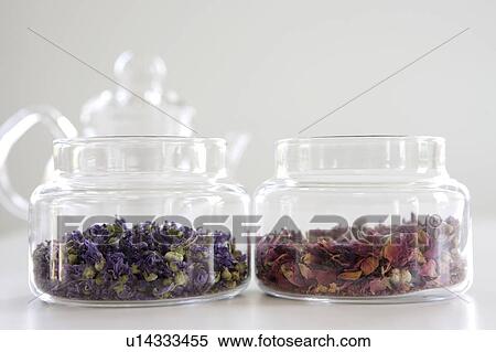 Stock Photography - Herbal tea made from lily and rose in glass jars. Fotosearch