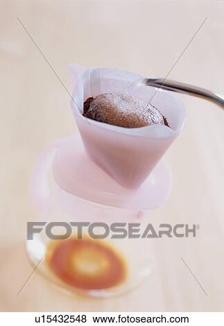 Stock Photo - Hot water being poured into coffee filter. Fotosearch