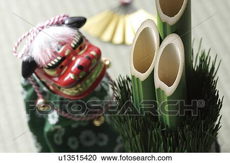 Stock Image - Kadomatsu, dancing lion doll and a fan. Fotosearch