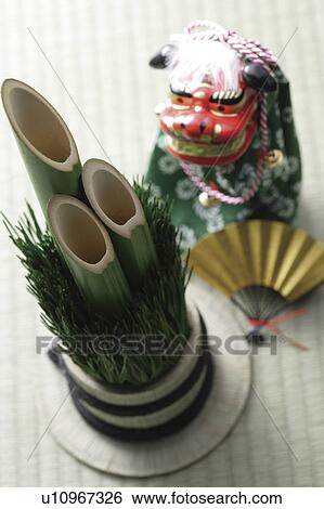 Stock Photograph - Kadomatsu, dancing lion doll and a fan. Fotosearch