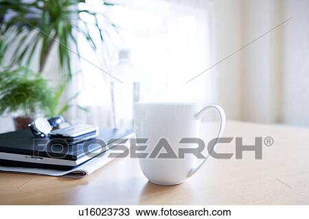 Laptop and mug on a table View Large Photo Image Stock Image - Laptop and mug on a table. Fotosearch