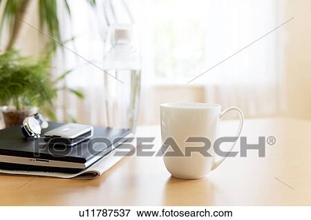 Laptop and mug on a table View Large Photo Image Stock Photo - Laptop and mug on a table. Fotosearch