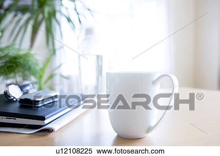 Stock Photography - Laptop and mug on a table. Fotosearch