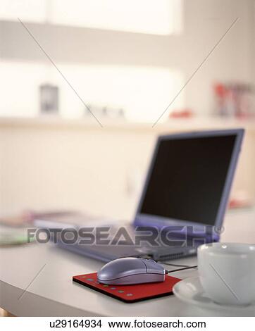 Picture - Laptop on table in house. Fotosearch