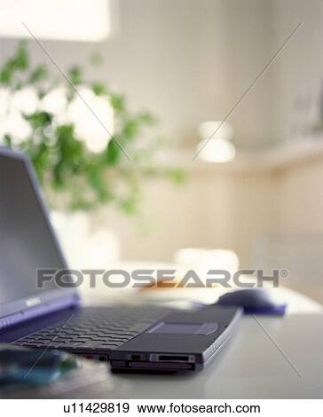 Laptop on table in house View Large Photo Image Stock Photo - Laptop on table in house. Fotosearch