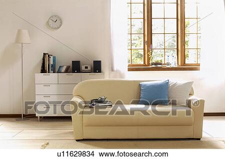 Picture - Living room with couch and drawers. Fotosearch