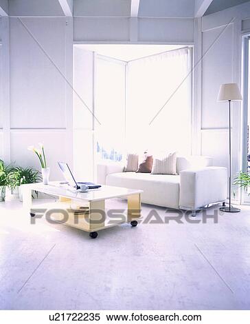 Living room with laptop on coffee table View Large Photo Image Stock Photography - Living room with laptop on coffee table. Fotosearch