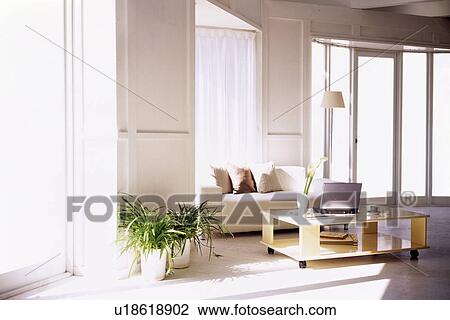 Living room with sofa and laptop on coffee table View Large Photo Image Stock Image - Living room with sofa and laptop on coffee table. Fotosearch