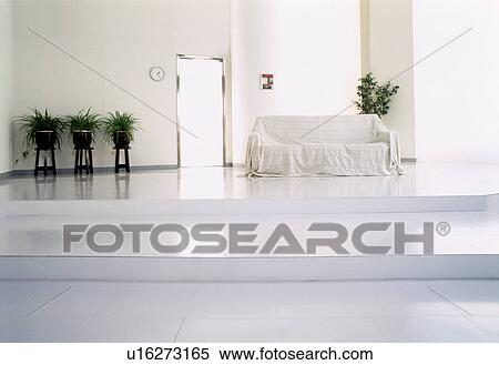 Stock Photography - Living room with sofa and potted plants. Fotosearch