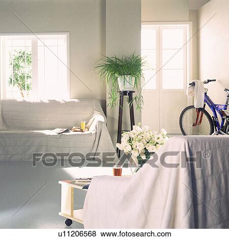 Stock Photo - Living room with sofas and bicycle. Fotosearch
