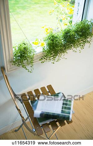 Magazine lying open on a chair View Large Photo Image Stock Photo - Magazine lying open on a chair. Fotosearch