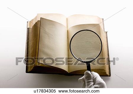 Stock Photography - Magnifying glass and antique book. Fotosearch