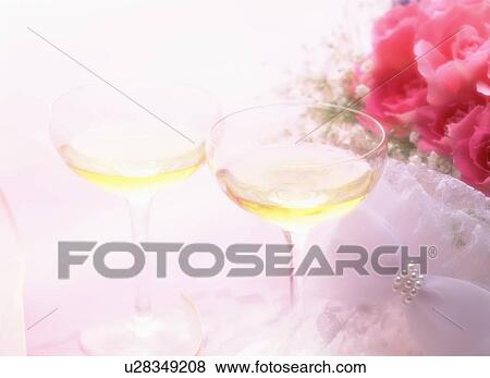 Stock Photo - Martini glasses next to pink flowers. Fotosearch