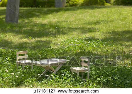 Miniature wooden chairs and table in a forest clearing View Large Photo Image Stock Photo - Miniature wooden chairs and table in a forest clearing. Fotosearch