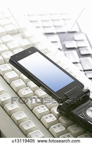 Mobile phone and computer keyboards View Large Photo Image Stock Photography - Mobile phone and computer keyboards. Fotosearch