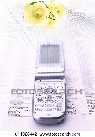 Mobile phone and flowers on a telephone directory View Large Photo Image Stock Image - Mobile phone and flowers on a telephone directory. Fotosearch