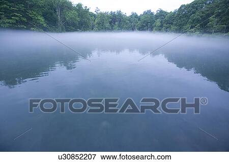 Morning haze over lake, Hokkaido, Japan View Large Photo Image Stock Photo - Morning haze over lake, Hokkaido, Japan. Fotosearch