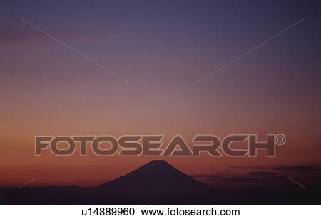 Stock Image - Mt Fuji at sunset in distance. Mt Yatsugatake, Yamanashi Prefecture, Japan. Fotosearch