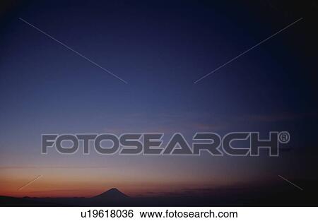 Stock Photograph - Mt Fuji at sunset in distance. Mt Yatsugatake, Yamanashi Prefecture, Japan. Fotosearch