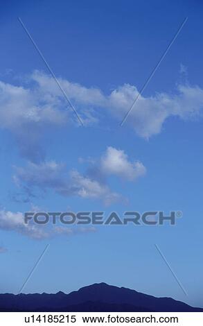 Mt. Fuji under clouds in a blue sky, Yamanashi Prefecture, Japan View Large Photo Image Stock Photography - Mt. Fuji under clouds in a blue sky, Yamanashi Prefecture, Japan. Fotosearch
