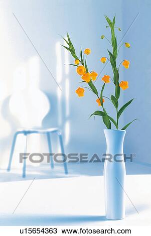 Orange flowers in a vase View Large Photo Image Stock Image - Orange flowers in a vase. Fotosearch