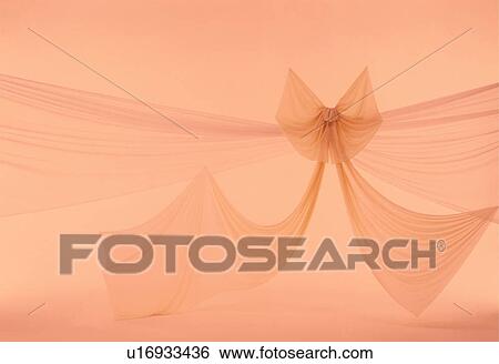Stock Photograph - Orange material tied in a bow. Fotosearch