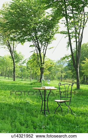 Outdoor chair and table set with water bottle in a park, Gassan, Shonai-machi, Yamagata Prefecture, Japan View Large Photo Image Stock Image - Outdoor chair and table set with water bottle in a park, Gassan, Shonai-machi, Yamagata Prefecture, Japan. Fotosearch