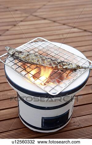 Pacific saury grilling on a charcoal brazier View Large Photo Image Stock Image - Pacific saury grilling on a charcoal brazier. Fotosearch