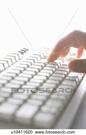 Stock Image - Person typing on keyboard. Fotosearch