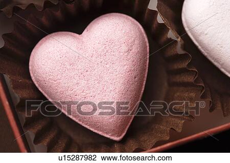 Stock Image - Pink candy heart in a cupcake wrapper. Fotosearch