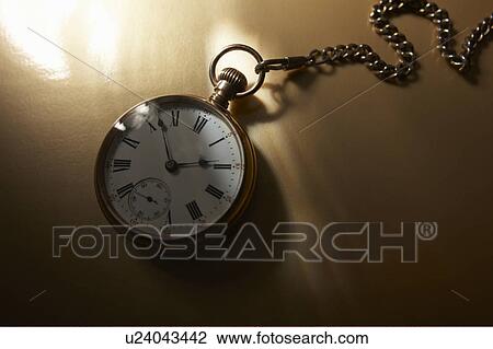 Stock Image - Pocket watch with chain. Fotosearch