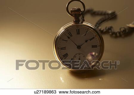 Stock Image - Pocket watch with chain. Fotosearch