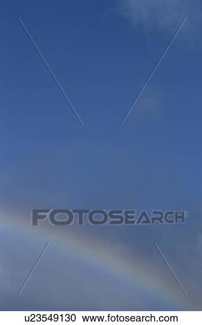 Rainbow against blue sky View Large Photo Image Stock Image - Rainbow against blue sky. Fotosearch
