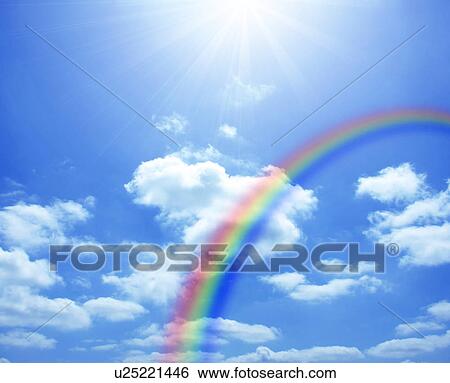 Stock Photograph - Rainbow and clouds in a sunny blue sky. Fotosearch