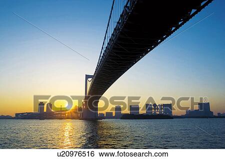 Stock Photograph - Rainbow bridge at sunrise, Minato Ward, Tokyo, Japan. Fotosearch