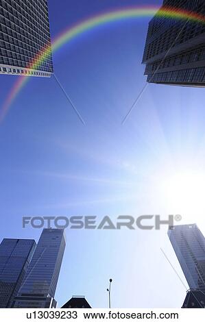 Stock Image - Rainbow over Marunouchi building group, Marunouchi, Chiyoda-ku, Tokyo, Japan. Fotosearch